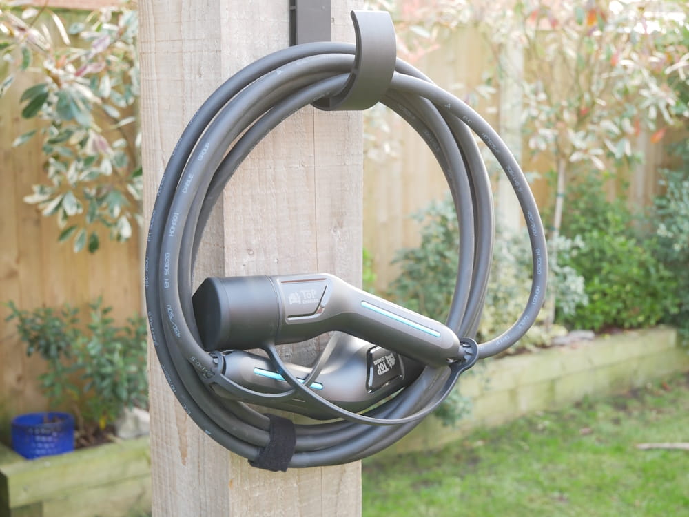 Top Charger Type 2 charging cable hung up on a wall mount